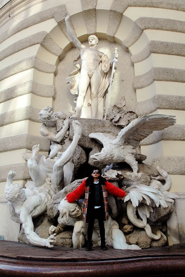 Bryanboy in front of Die Macht zu Lande (The Power on Land) fountain by Edmund Hellmer at Michaelertrakt of Hofburg Palace