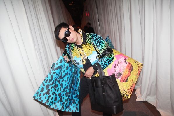 Bryanboy carrying Versace for H&M paper bags