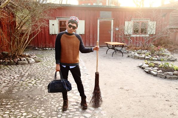 Bryanboy holding a broomstick in Skansen