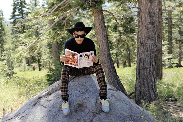 Bryanboy reading the September 2012 issue of Glamour magazine featuring Victoria Beckham on the cover.