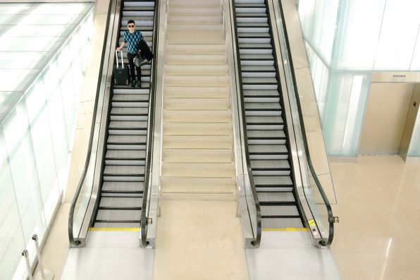 Bryanboy going down the escalators at Washington Dulles International airport