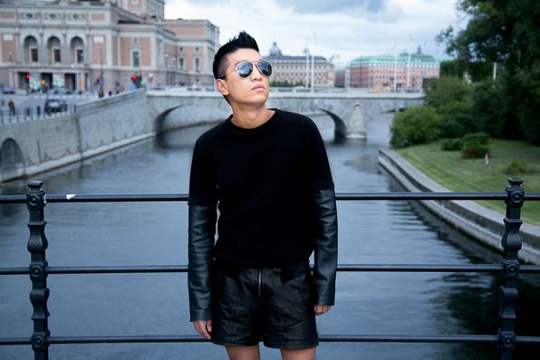 Bryanboy wearing a leather-sleeved COS top in Stockholm