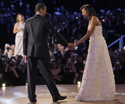 Barack and Michelle Obama dancing. Michelle Obama's white dress was designed by Taiwanese-American designer Jason Wu.
